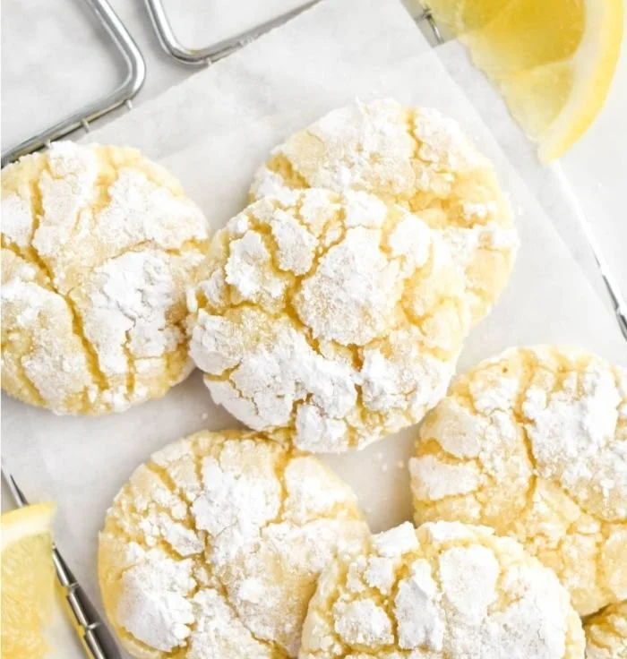 Freshly baked Lemon Crinkle Cookies dusted with powdered sugar