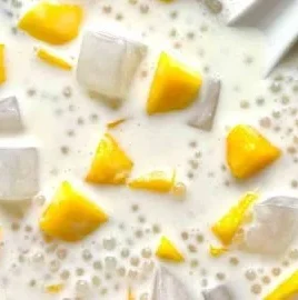 A vibrant Mango Bango drink garnished with fresh mango slices.