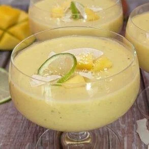 Delicious Mango Coconut Dessert Cups topped with fresh mango and coconut flakes