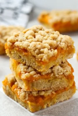 Delicious mango crumble bars with golden crumble topping on a plate