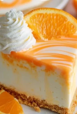 Slice of delicious Orange Creamsicle Cheesecake with orange zest and cream topping