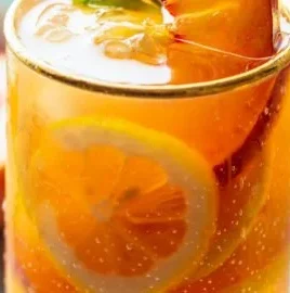 Refreshing Peach Iced Tea Lemonade in a glass with peach slices