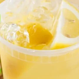 A refreshing glass of State Fair Lemonade with a slice of lemon on the rim