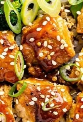Delicious sticky hot honey garlic chicken bowls garnished with green onions.