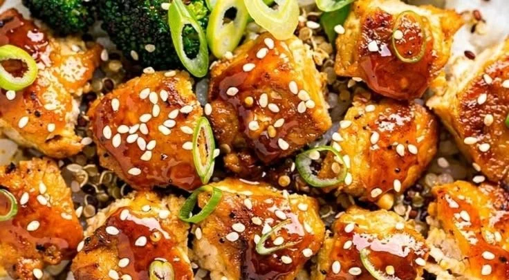 Delicious sticky hot honey garlic chicken bowls garnished with green onions.