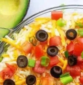Delicious 7 layer dip served in a colorful dish
