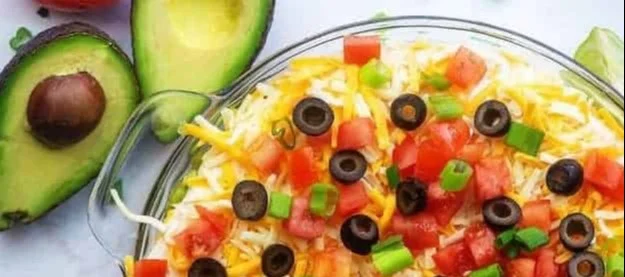 Delicious 7 layer dip served in a colorful dish