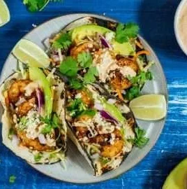 Delicious Baja Shrimp Taco served with fresh toppings and lime.