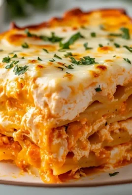 Cheesy Buffalo Ranch Chicken Lasagna dish served hot with toppings
