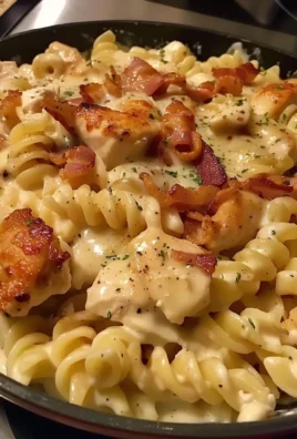 Creamy Chicken Bacon Ranch Pasta served in a bowl with bacon and herbs