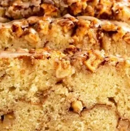 Freshly baked cinnamon apple bread with slices on a wooden board