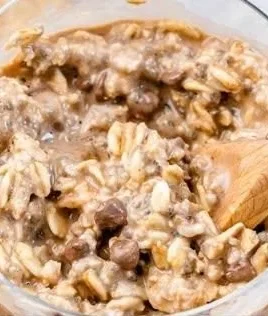 Bowl of cookie dough overnight oats topped with chocolate chips and nuts