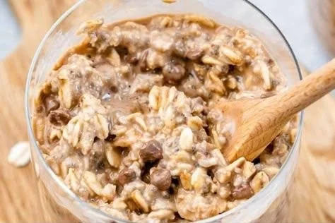 Bowl of cookie dough overnight oats topped with chocolate chips and nuts