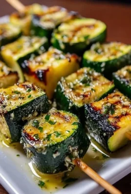 Grilled garlic butter zucchini skewers on a barbecue grill