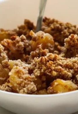 Healthy breakfast apple crumble topped with oats and fresh apples