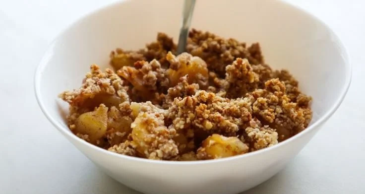 Healthy breakfast apple crumble topped with oats and fresh apples