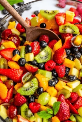 A vibrant and colorful bowl of killer fruit salad with assorted fresh fruits