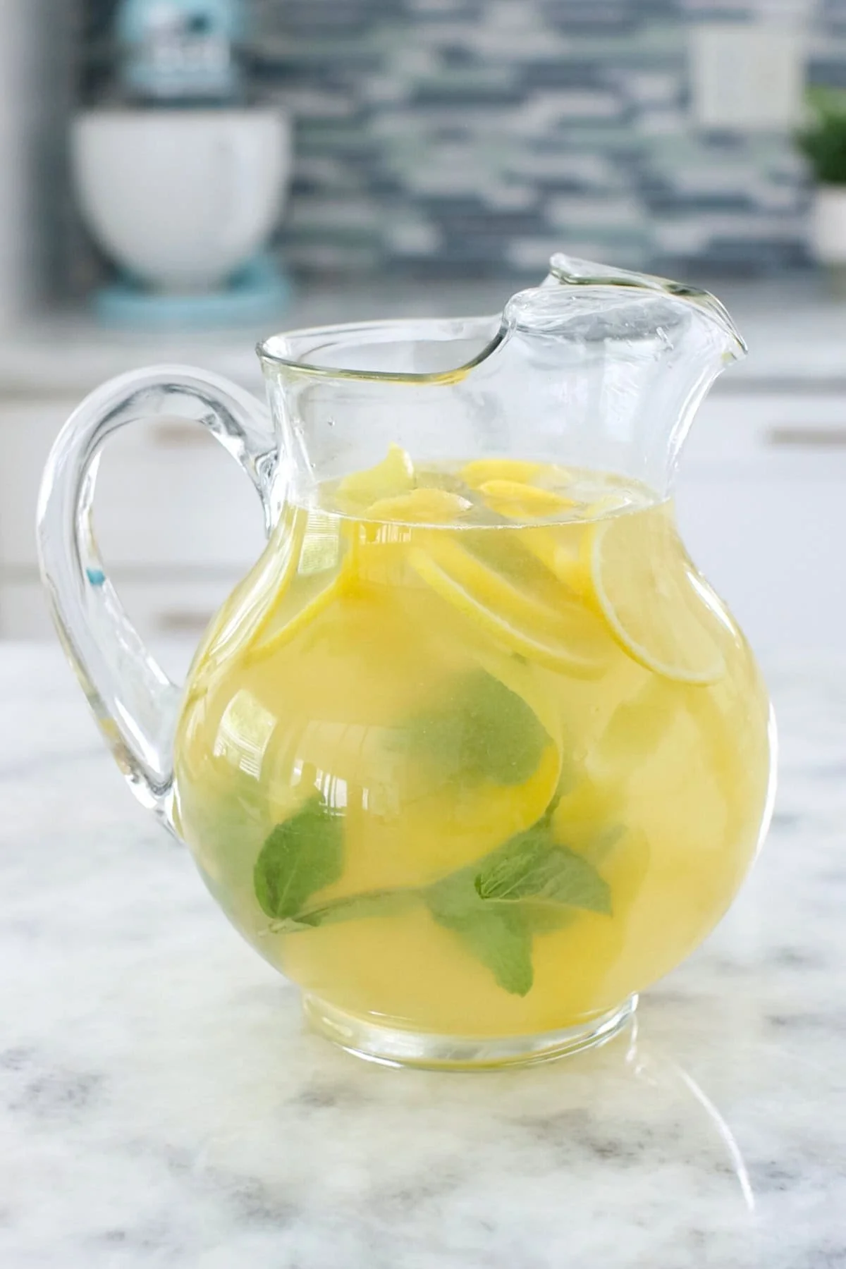 A glass of refreshing mint lemonade with mint leaves and lemon slices