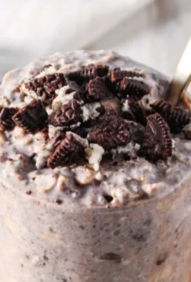 Bowl of delicious Oreo Overnight Oats topped with crushed Oreos and chocolate.