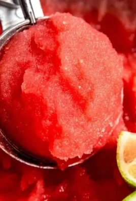 Homemade watermelon sorbet served in a bowl, garnished with mint leaves.